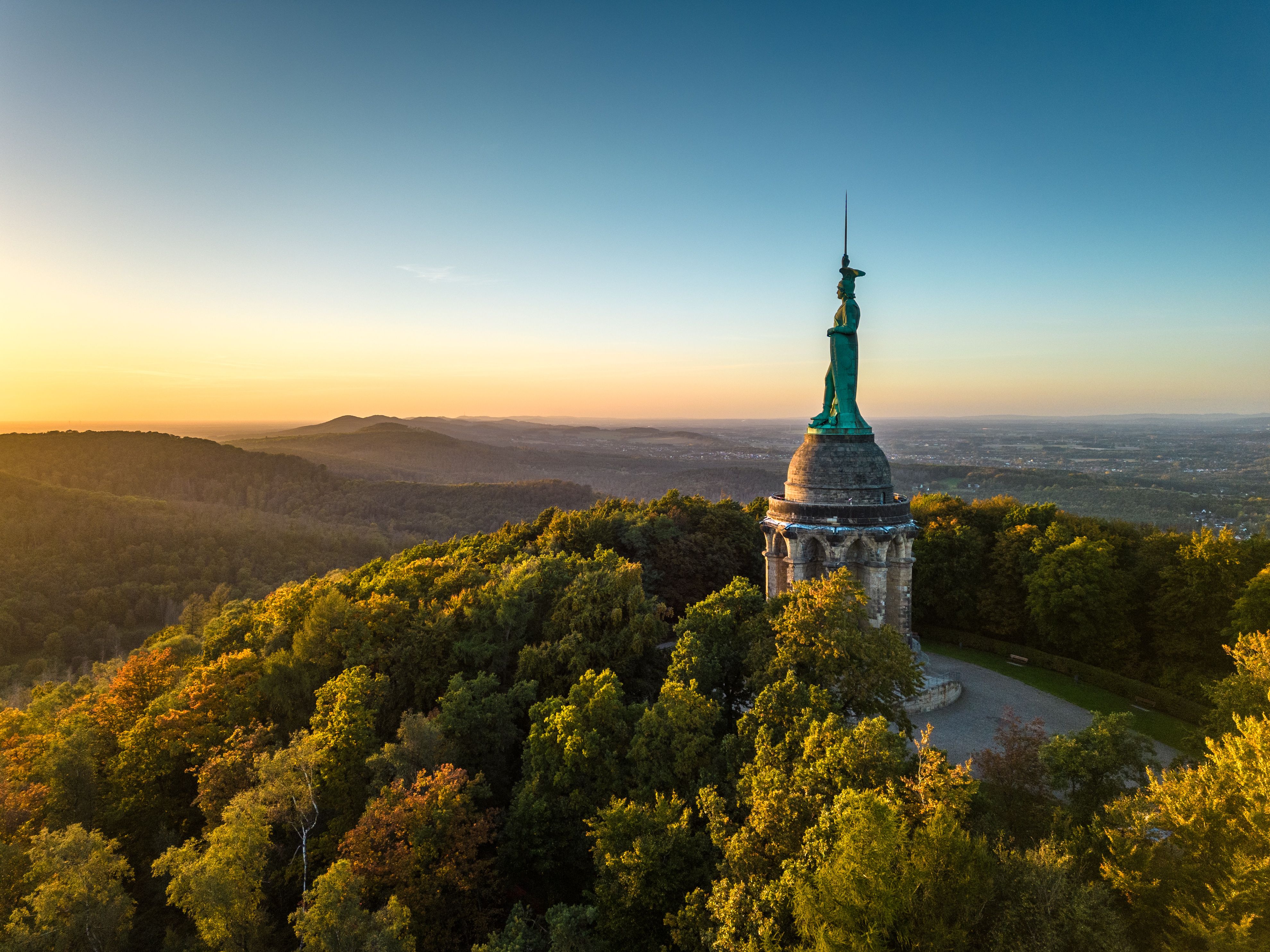 Luftaufnahme des Hermannsdenkmals im Teutoburger Wald bei Sonnenuntergang.