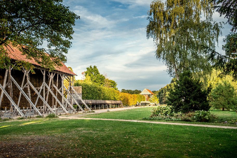 Ein Park mit einem Gradierwerk und grüner Landschaft im Salinenpark Rheine.