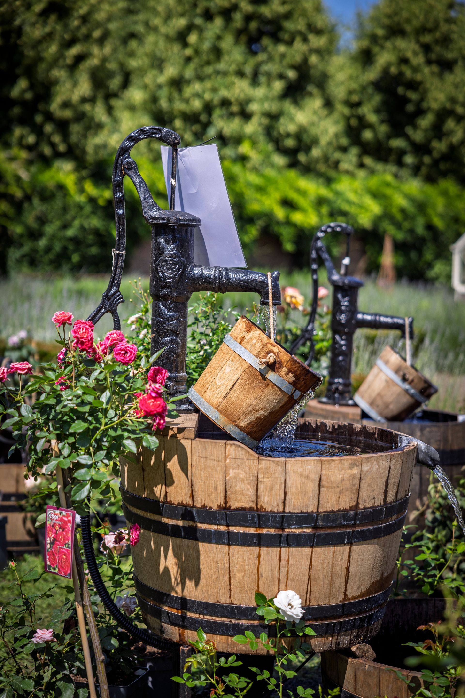 Gartenbrunnen aus Holzfässern und Wasserpumpen sorgen für die richtige Wasserversorgung