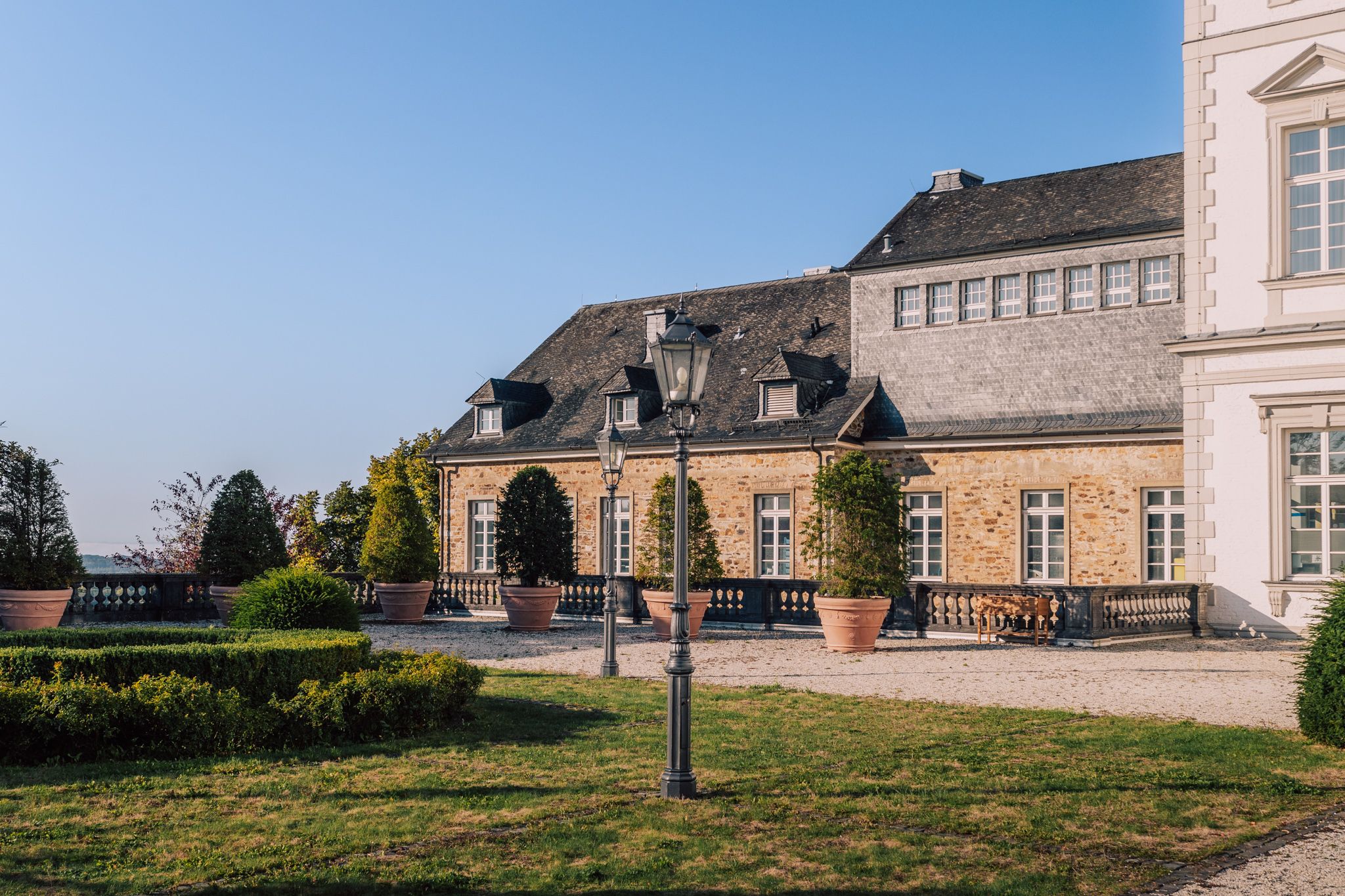 Außenansicht des Grandhotels Schloss Bensberg mit Blick auf den Garten im Herbst